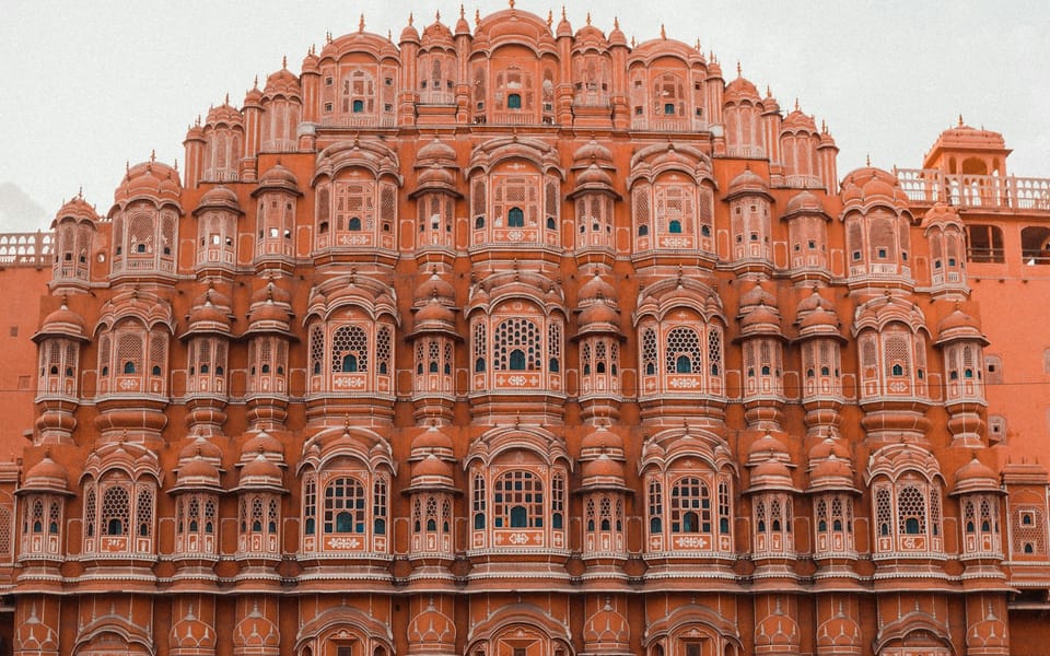 The tiered pink facade of a historic building in Jaipur's old city